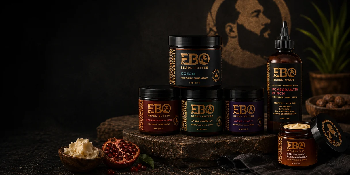 EBO beard butter jars in Ocean, Pomegranate Punch, Aruba Coconut and Ladies Love It scents stacked on dark stone beside a beard wash bottle.